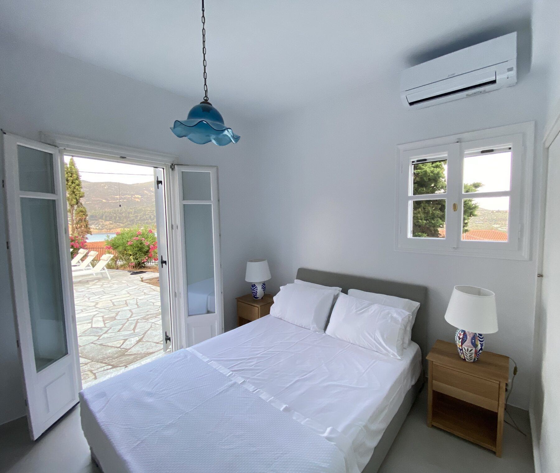 Main bedroom with doors opening onto the pool terrace