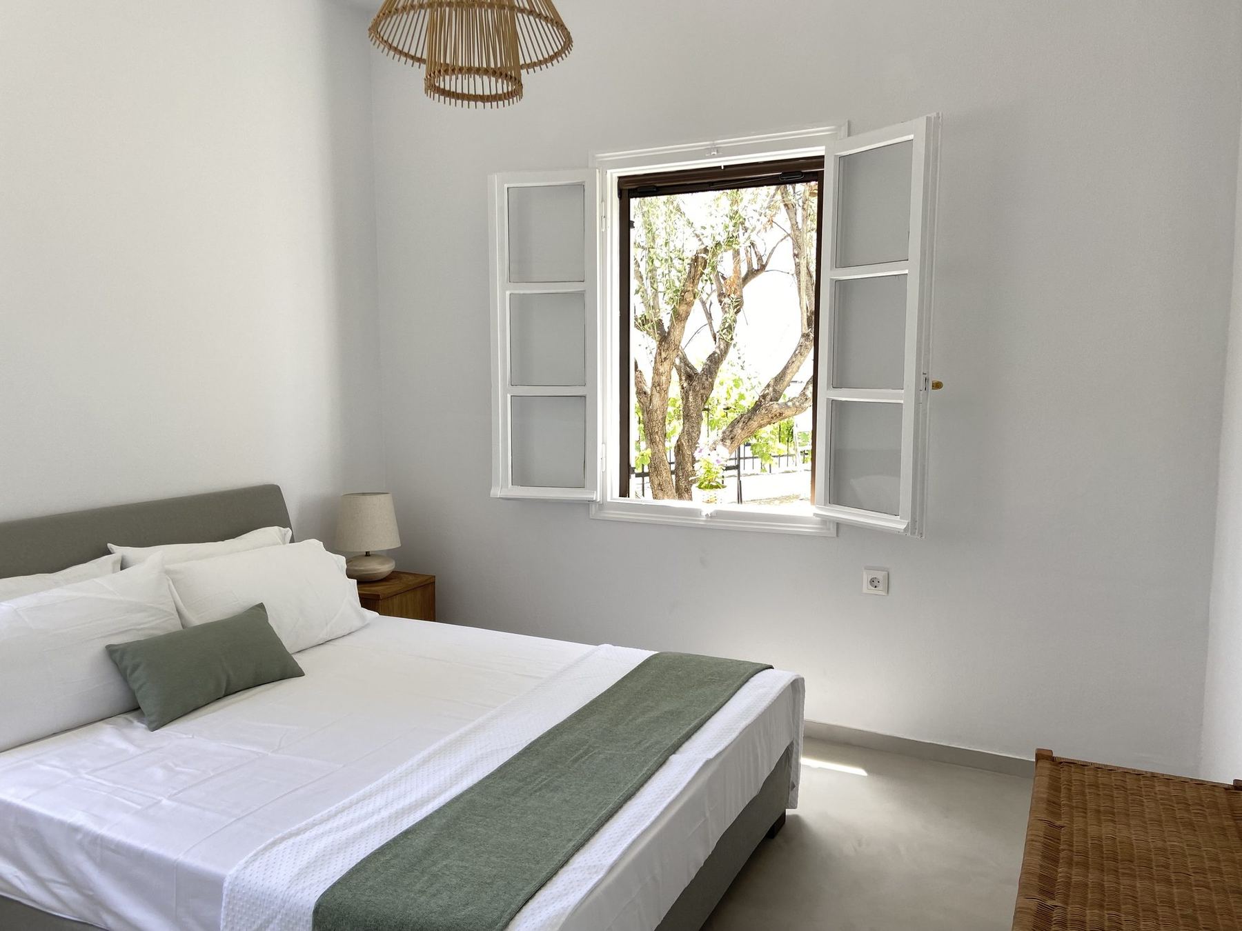Bedroom two, shutters open onto the garden