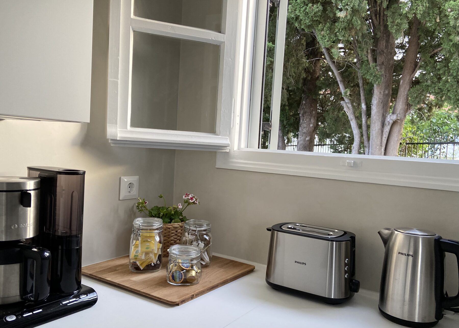 Kitchen counter with coffee machine, kettle and toaster
