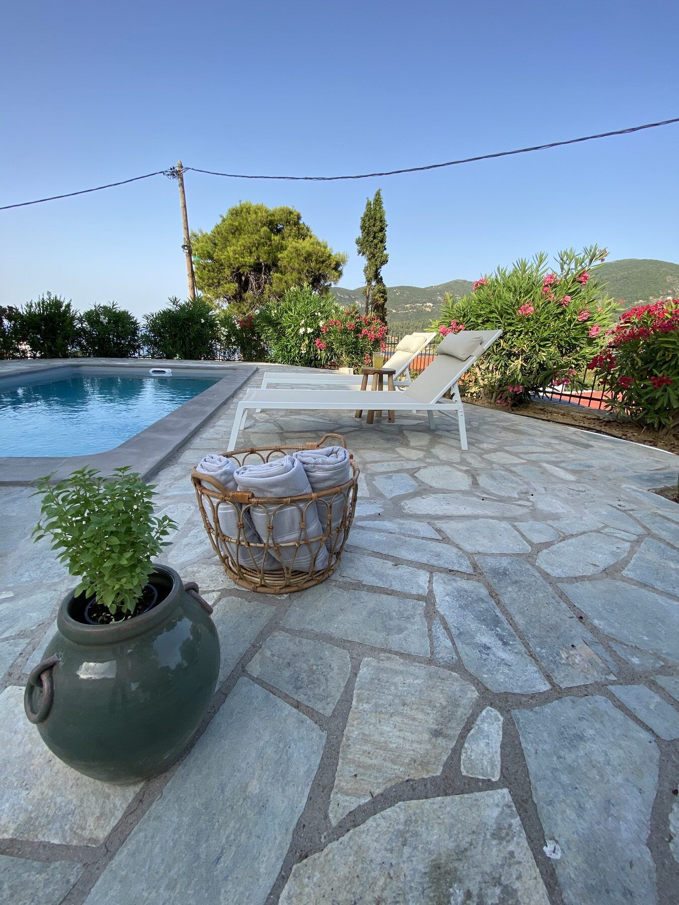 Loungers and rolled towels beside the pool at Villa Icelle